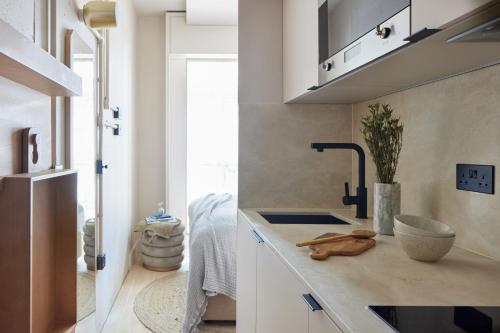 a kitchen with a sink and a counter top at Buckle Street Studios by Locke in London