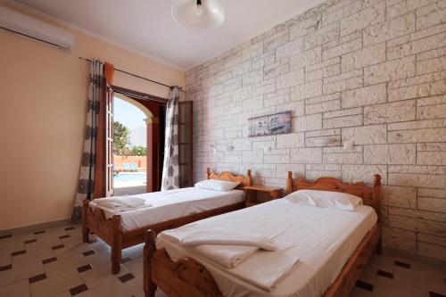 Postel nebo postele na pokoji v ubytování LUISA HOTEL