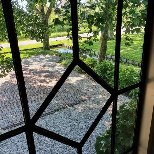 a view from a window of a garden at Op Stolk bed & breakfast in Stolwijk