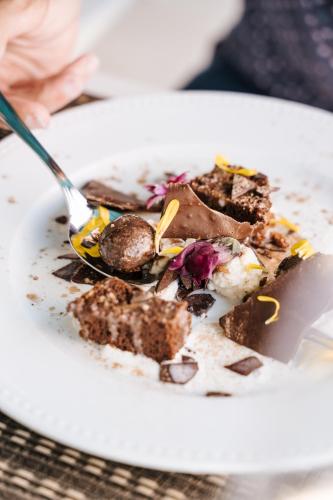 a plate of food on a table with a fork at Conimbriga Hotel do Paço in Condeixa a Nova
