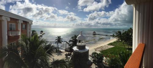 a view of the ocean from a balcony of a resort at Lighthouse Beach Villas in San Pedro