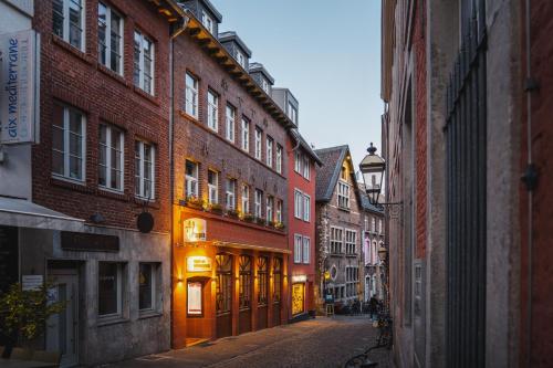 an empty street in an old city with buildings at Haus am Hühnerdieb in Aachen