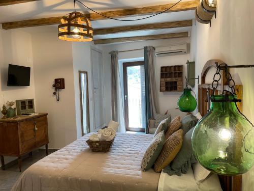 a bedroom with a large bed and a large window at Giardino delle Zagare in Piazza Armerina