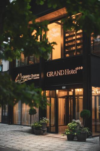 a grand hotel with potted plants in front of it at Grand Chotowa Hotel Spa & Resort in Chotowa