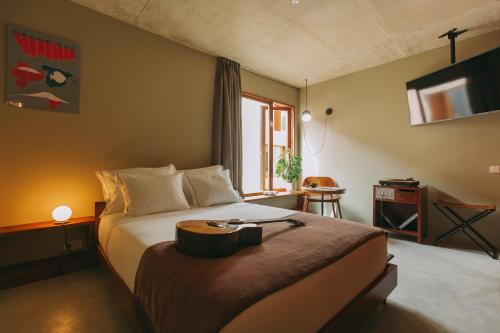 a hotel room with a bed with a tray on it at Outsite Porto Mouco in Porto