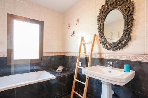 a bathroom with a sink and a mirror at Villa Sol Wifi Fibra in Lajares