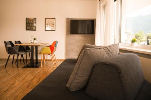 a living room with a couch and a table at Hotel verWeiler in Fischen