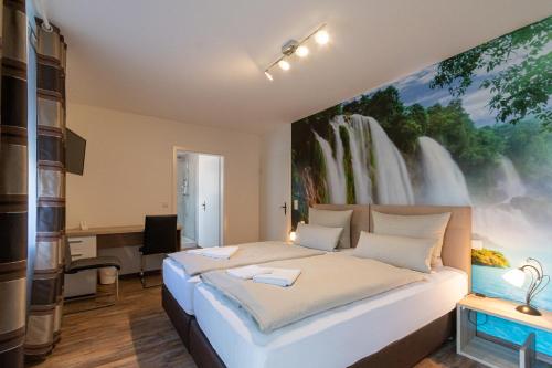 a bedroom with a bed with a large painting on the wall at Hotel Mettlacher Hof in Mettlach