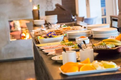 a buffet with plates of food on a table at Hotell Funäsdalen in Funäsdalen