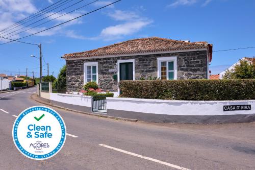 a small stone house with a sign in front of it at Casa D'Eira in Nordeste