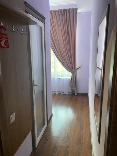 an empty room with a door and a window at Grand Hotel in Mohyliv-Podilʼsʼkyy