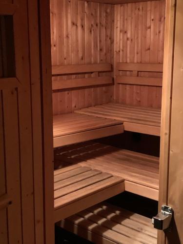 a sauna with wooden shelves in a wooden room at Quellenhof C01 in Davos