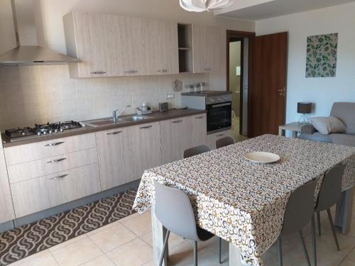 una cucina con tavolo e sedie e una sala da pranzo di Dabliu House a Torrenova