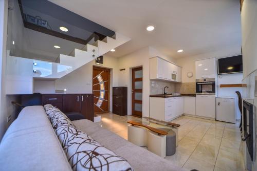 a large living room with a couch and a kitchen at Diamond Club Zlatibor in Zlatibor