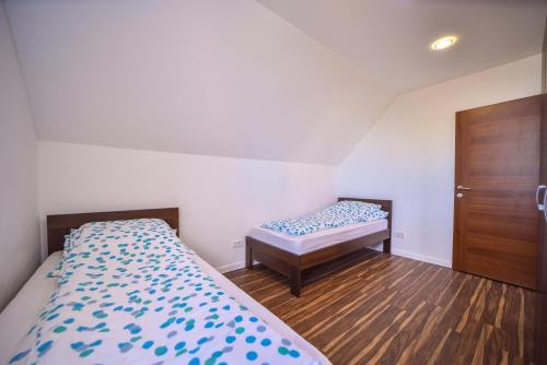 a bedroom with two beds and a wooden door at Diamond Club Zlatibor in Zlatibor