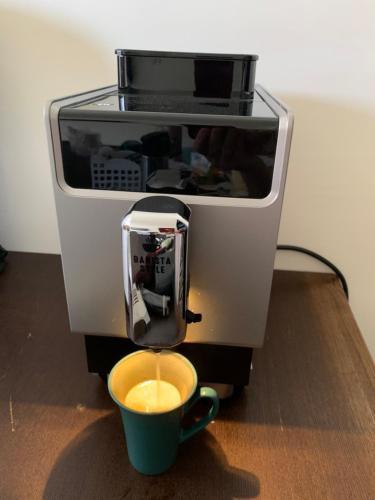 a coffee maker with a cup of coffee at Duke 369 in Donggang