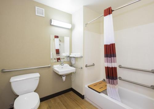 a bathroom with a toilet and a sink at Red Roof Inn PLUS+ Columbus Downtown - Convention Center in Columbus