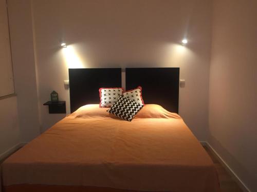 a bedroom with a bed with two pillows on it at Douro - A Casinha da Ana in Vila Real