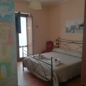 a bedroom with a bed and a television and a window at B&B Genti delle Alture in Apice