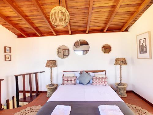 a bedroom with a bed with a wooden ceiling at Pôr do Sol by LovelyStay in Calheta
