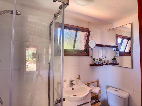 a bathroom with a toilet and a sink and a shower at Pôr do Sol by LovelyStay in Calheta