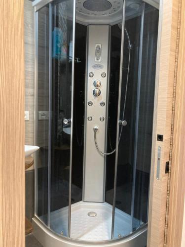 a shower with a glass door in a bathroom at Le Gildien in Bardonecchia