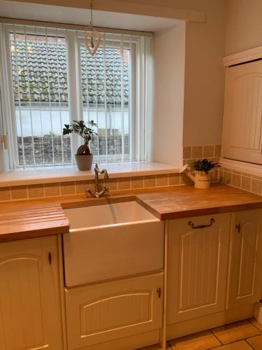 a kitchen with a sink and a window at Parkside Mews in Frizington