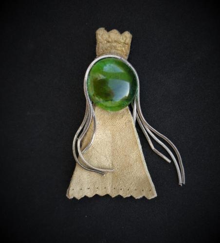 a green gemstone in a pendant on a black background at Glezant in Mitzpe Ramon