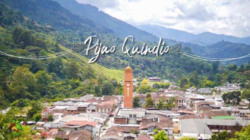 a city with a clock tower in the middle of a town at Finca TRADICIONAL EL OTOÑO in Pijao