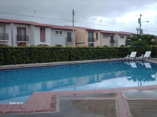 a swimming pool in front of some buildings at Metrópolis Apartaments for Rent in Guayaquil