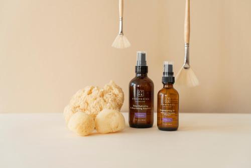 two bottles of essential oils and a stuffed animal at NaNa Vida Hotel Oaxaca in Oaxaca City