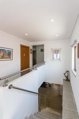 a staircase in a building with white walls at Isabel do Couto - casa de charme in Castro Daire