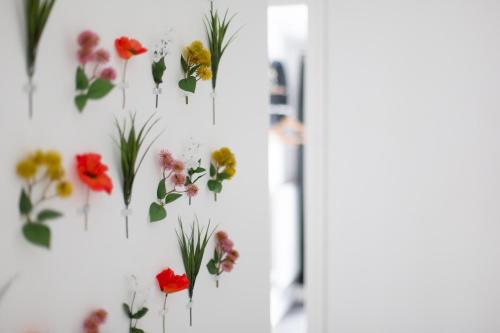 a bunch of flowers hanging on a wall at Cozy Cribs near Zipworld, Dare Valley Bike Park, Pen-y-fan & Four Waterfalls Walk in Aberdare