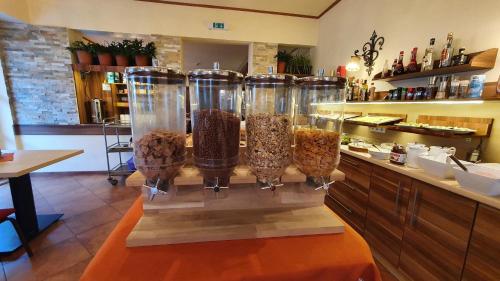a display of food in four glass containers on a counter at IMBACHHORN Pension in den Alpen in Fusch an der Glocknerstraße