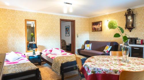 a living room with two beds and a couch at Apartament Przy Słonecznej in Mysłakowice