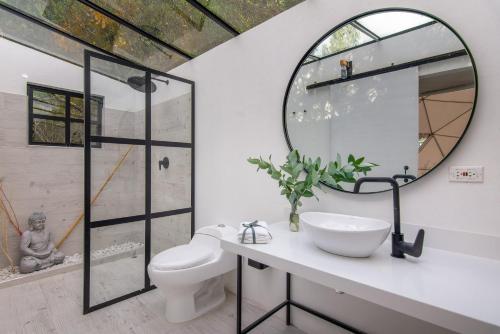 a bathroom with a sink and a mirror at TERRA LUNA GLAMPING in Paipa