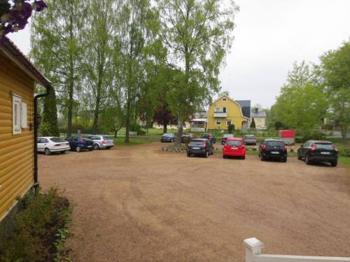 a group of cars parked in a parking lot at Furuliden Country Inn in Vittsjö