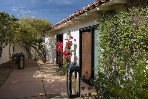 a building with a door and flowers on it at The Colony Palms Hotel and Bungalows - Adults Only in Palm Springs