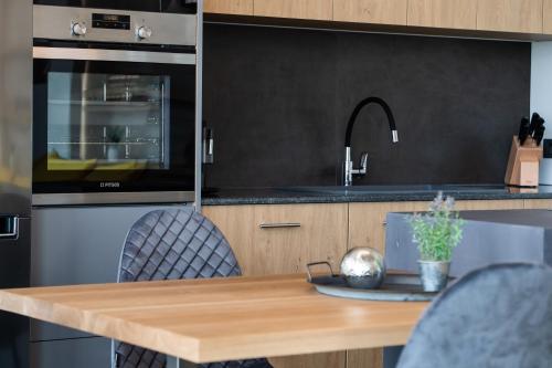 a kitchen with a wooden table and a sink at Ionian Grand Villas - Villa Estella in Lygia