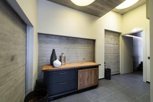 a room with a counter and a wall with a vase at Ionian Grand Villas - Villa Estella in Lygia