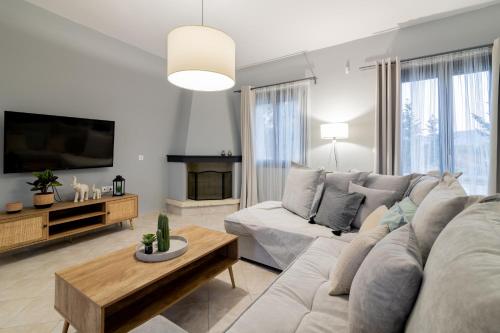 a living room with a couch and a table at Nimar Villa in Gaïtánion