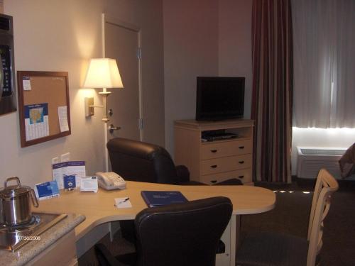 a hotel room with a desk and a room at Candlewood Suites Paducah by IHG in Paducah