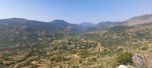 a view of a mountain valley with a dirt road at VILA DISHA in Tirana