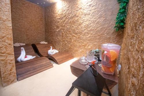 a room with two swans sitting on benches and a room with tables at Soho Boutique Holbox - Adults Only in Holbox Island
