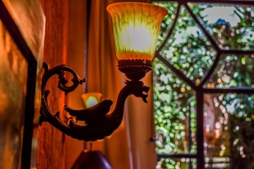a lamp that is attached to a window at Meson Panza Verde in Antigua Guatemala