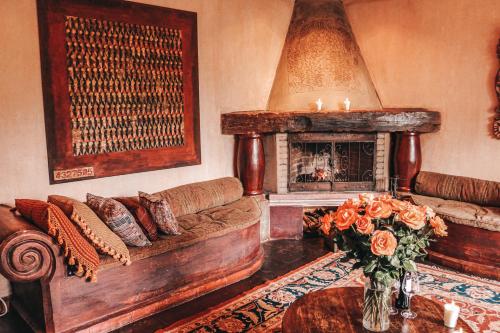 a living room with a couch and a fireplace at Meson Panza Verde in Antigua Guatemala