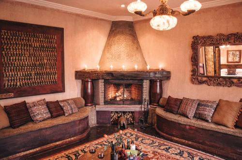 a living room with a couch and a fireplace at Meson Panza Verde in Antigua Guatemala