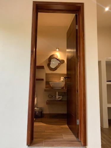 a bathroom with a mirror and a sink at Casa Delfín Tulum in Macario Gomez