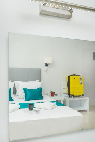 a room with two beds and a yellow suitcase at Lux VIP Apartments in Perea