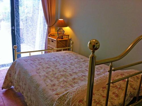 a bedroom with a bed and a lamp and a window at Sweet Night in Perugia
